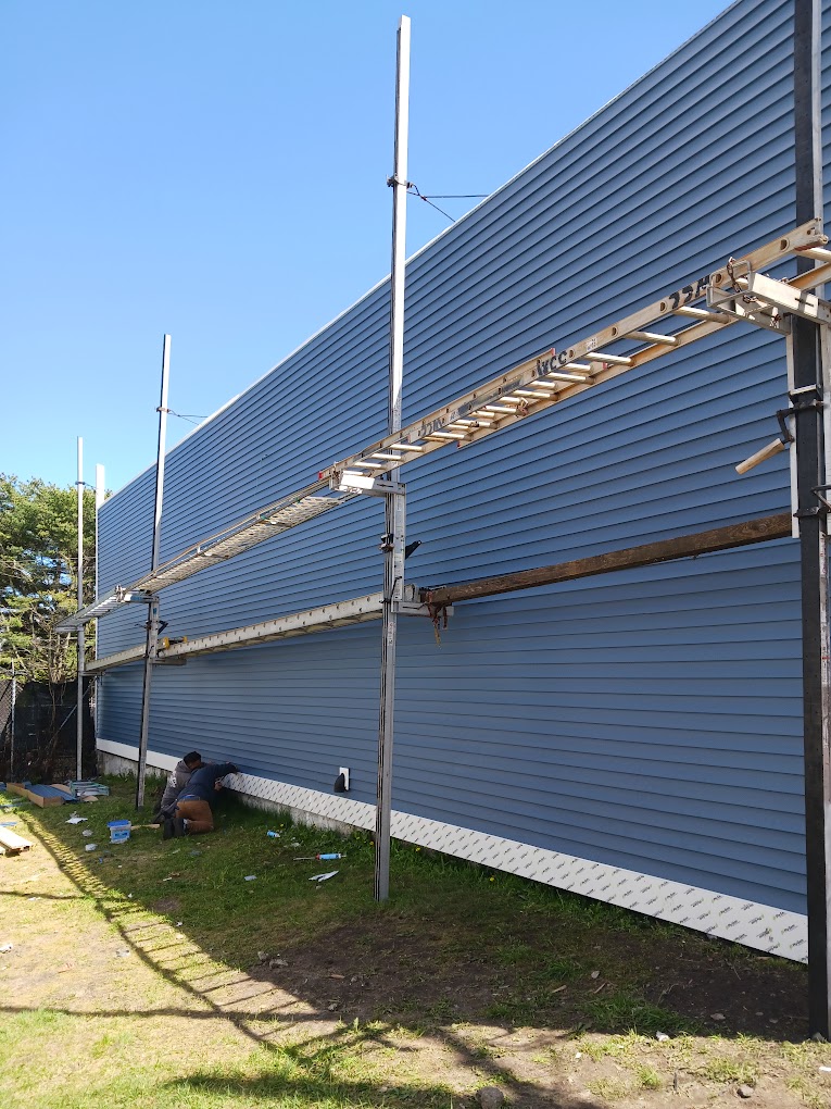 Blue siding scaffolding